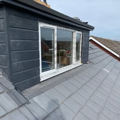 Hogans Roofing team member inspecting a roof