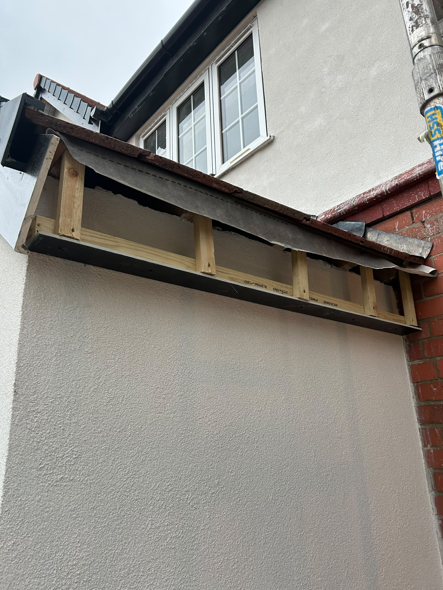 Timber soffit framing beneath a tiled roof overhang