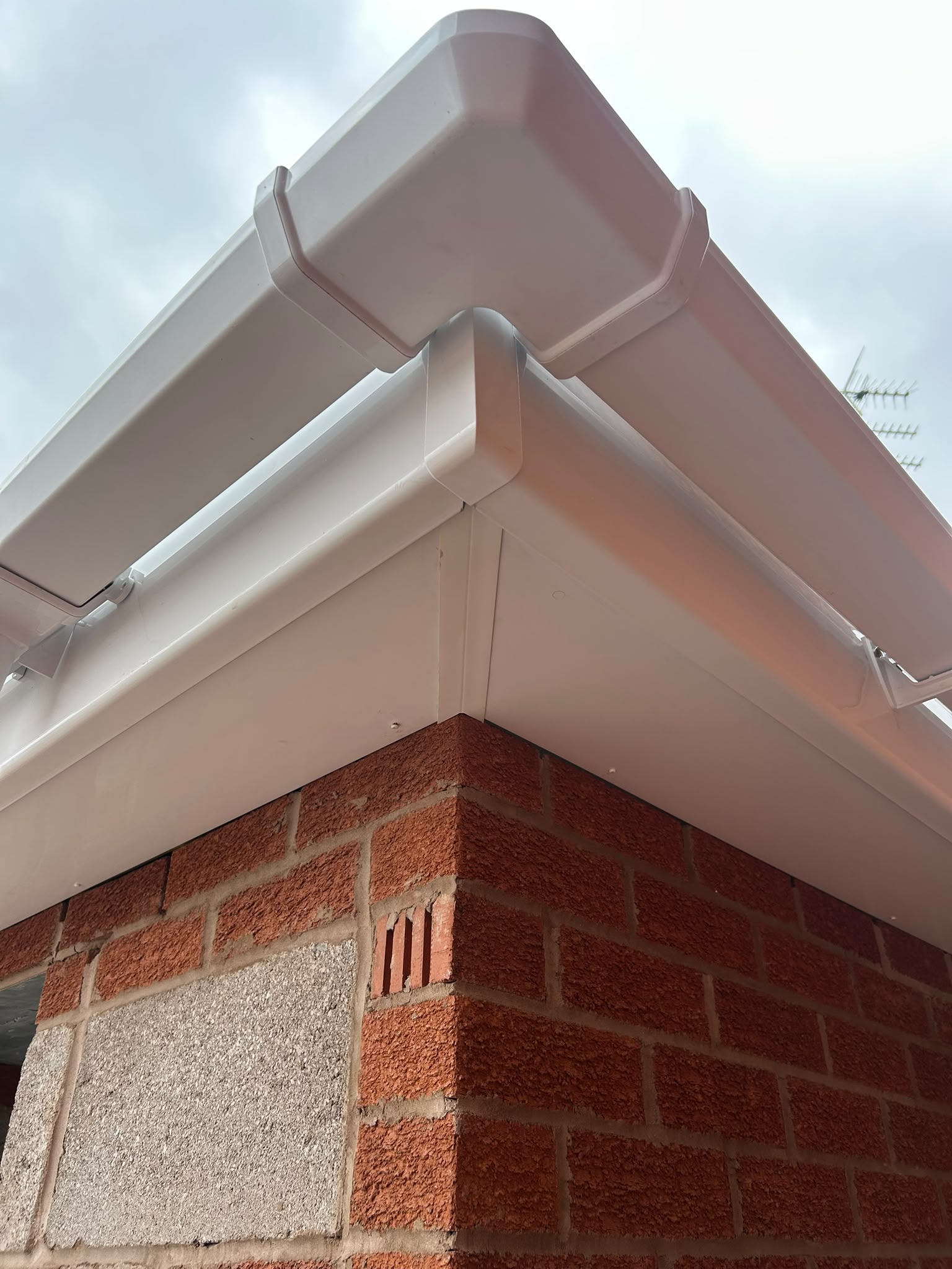White uPVC gutter and fascia on red brickwork